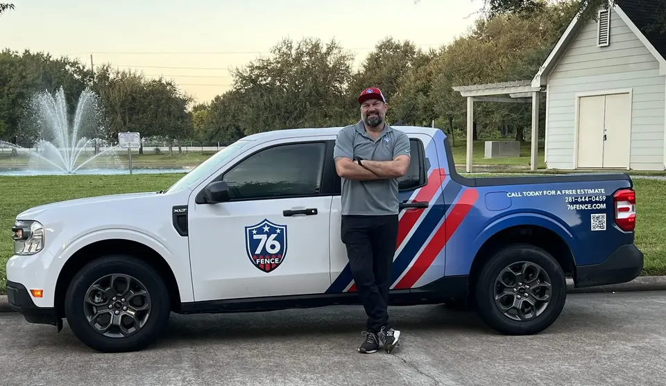 76 Fence team member beside a branded 76 Fence truck